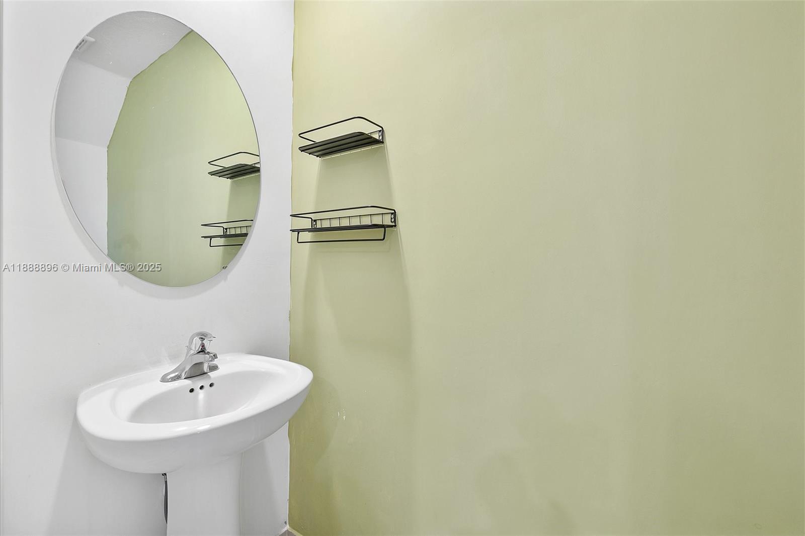 10013 Southwest 228th Terrace, Unit 10013 Miami, FL 33190 - Photo 17 of 39 a bathroom with a sink and a mirror