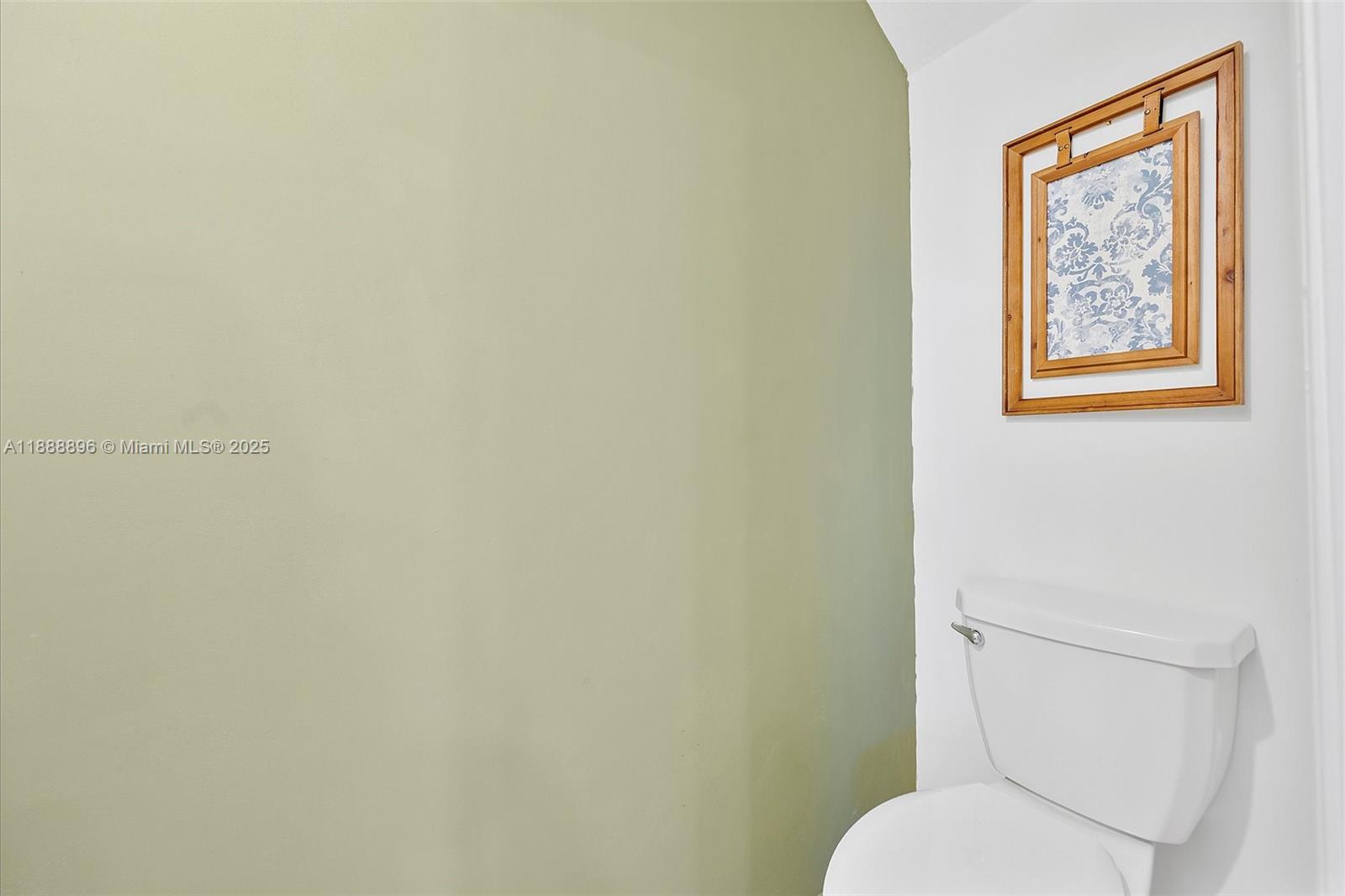 10013 Southwest 228th Terrace, Unit 10013 Miami, FL 33190 - Photo 18 of 39 a white toilet sitting next to a white wall