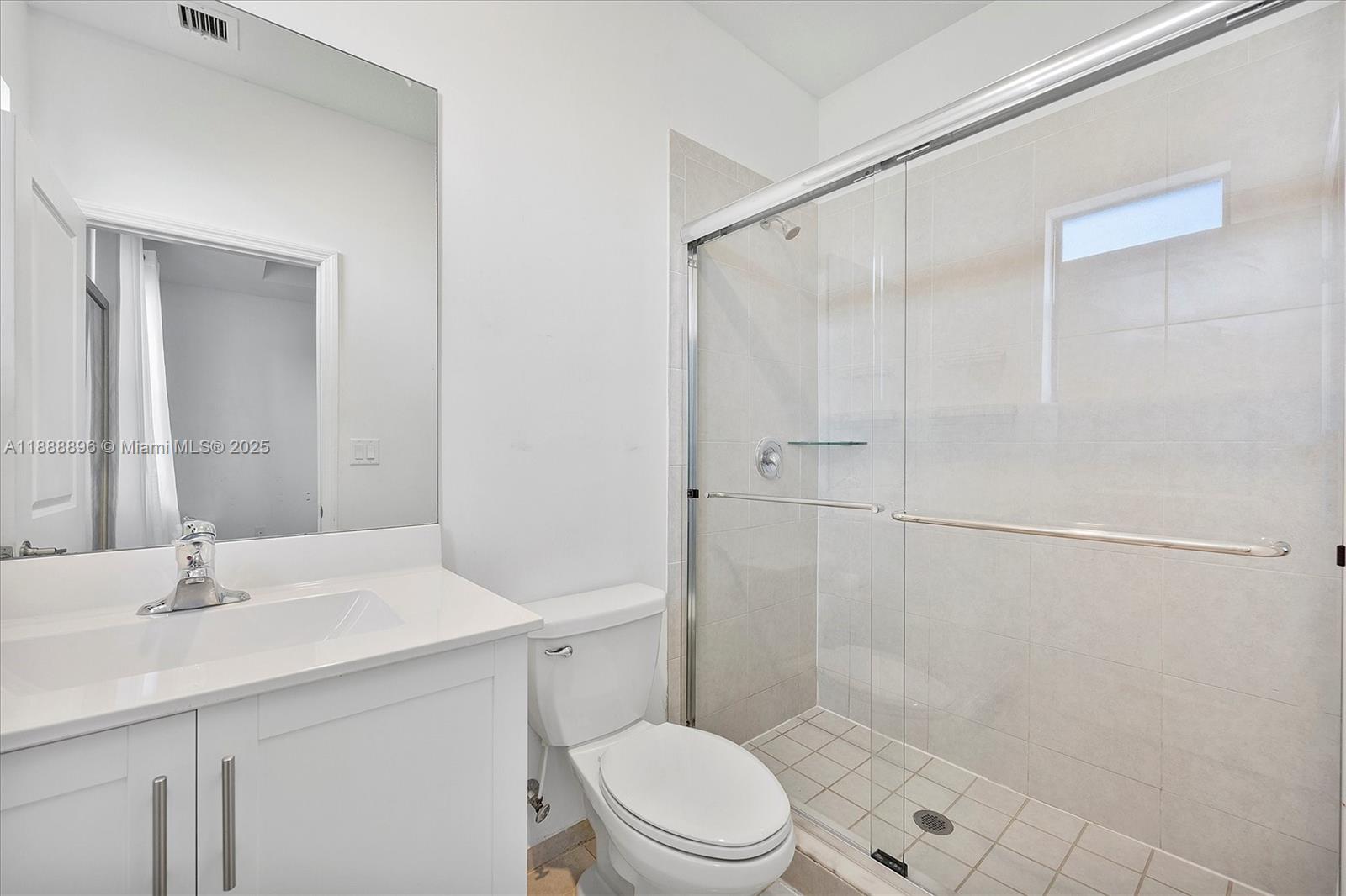 10013 Southwest 228th Terrace, Unit 10013 Miami, FL 33190 - Photo 25 of 39 a bathroom with a sink a toilet and shower