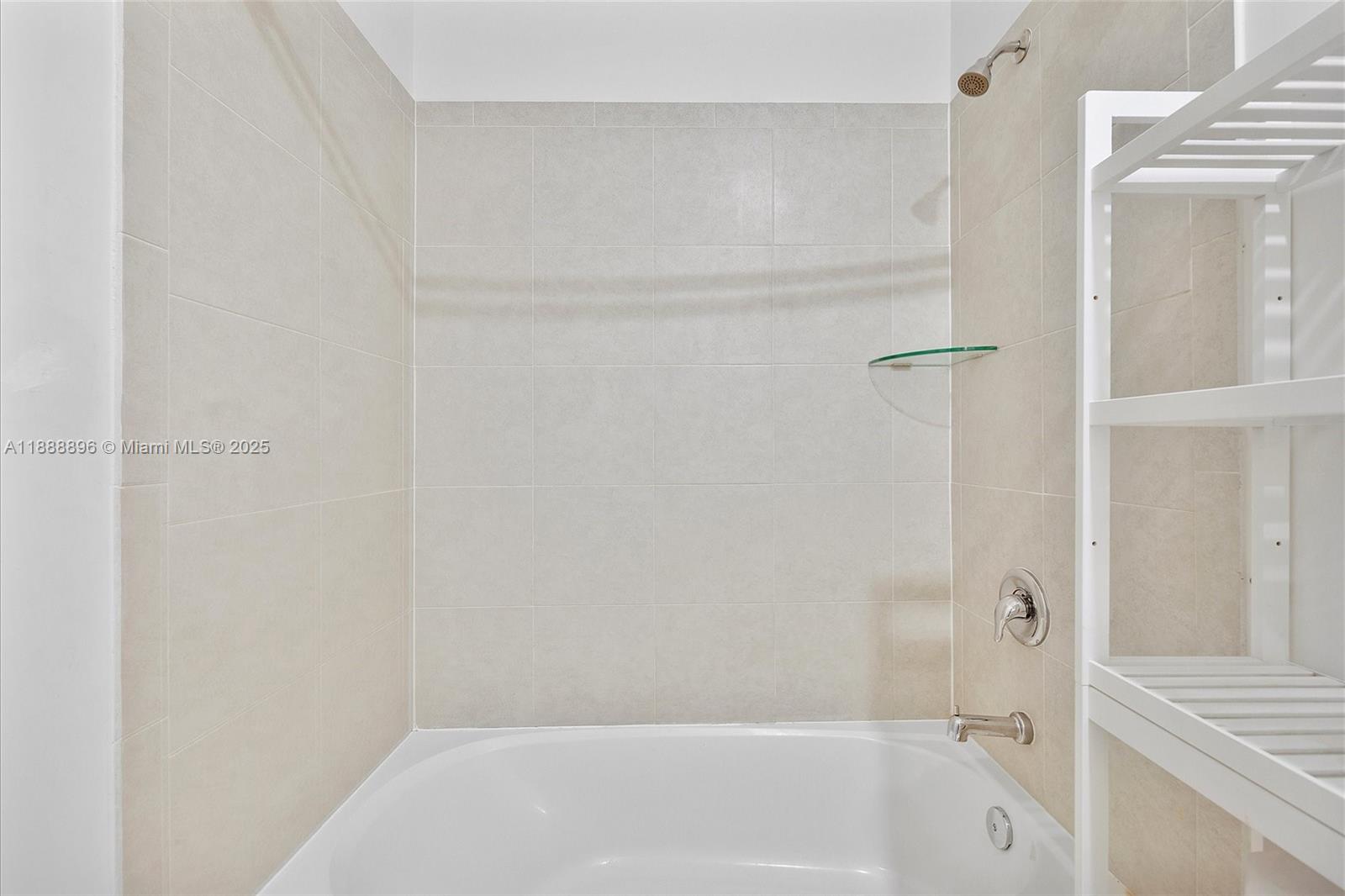 10013 Southwest 228th Terrace, Unit 10013 Miami, FL 33190 - Photo 31 of 39 a bathroom with a bathtub