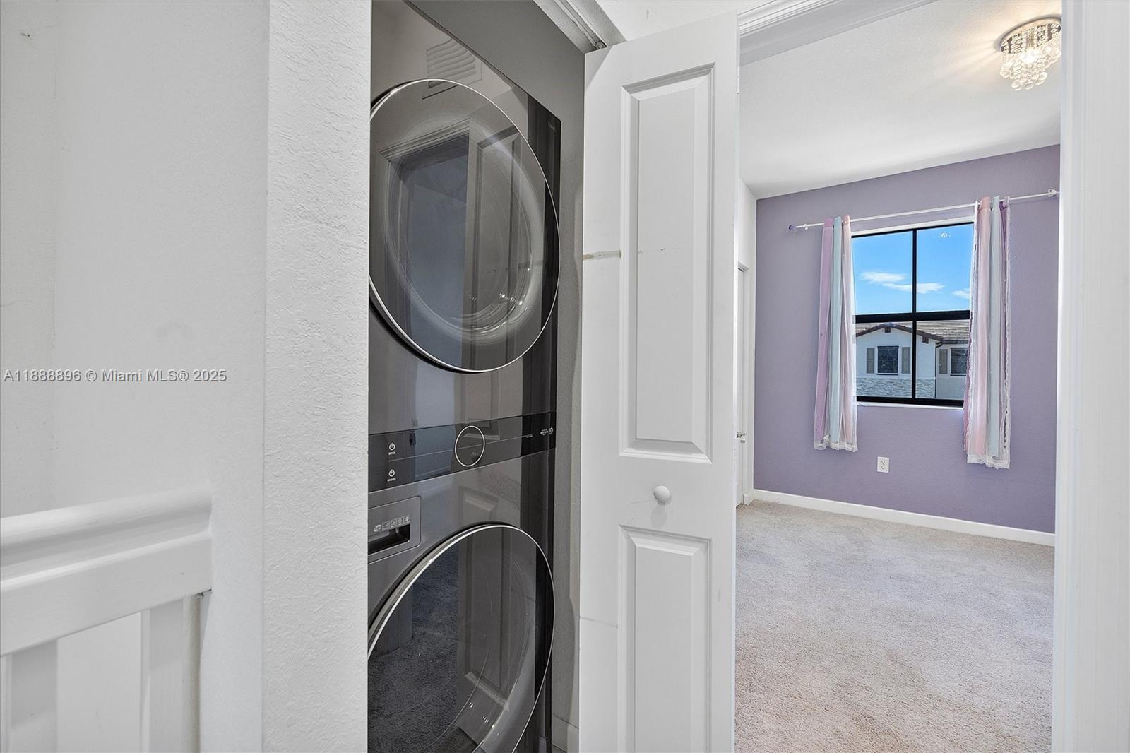 10013 Southwest 228th Terrace, Unit 10013 Miami, FL 33190 - Photo 35 of 39 a bathroom with a sink a washer and dryer