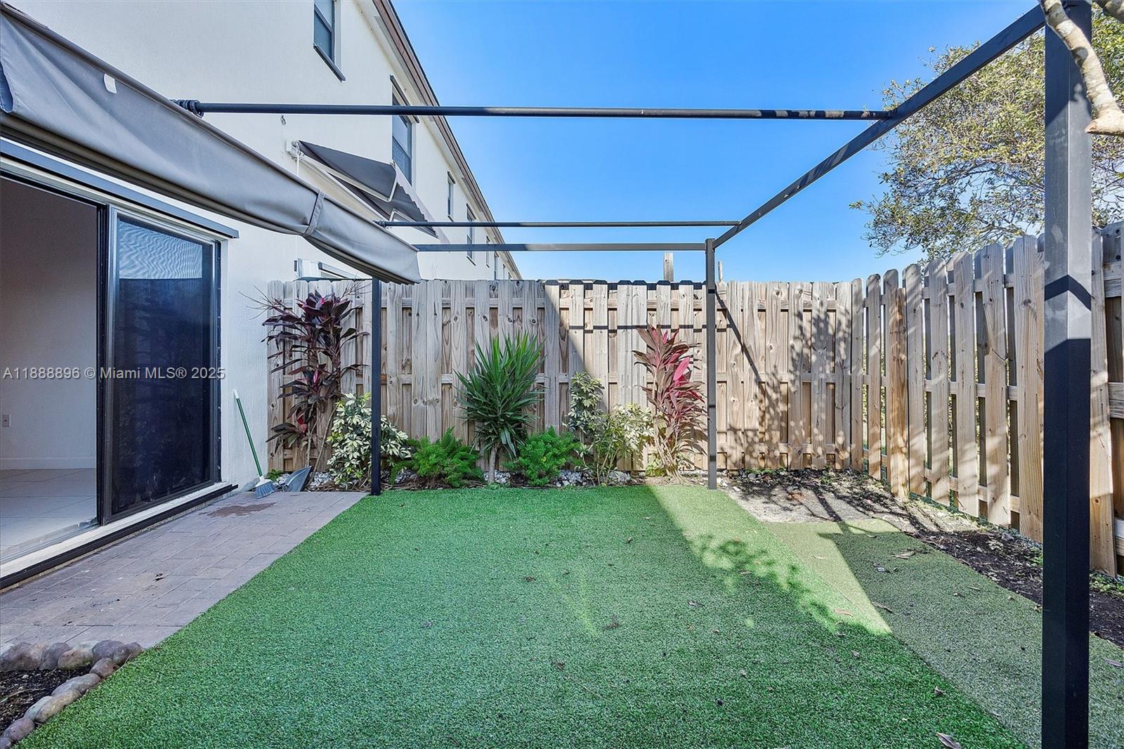 10013 Southwest 228th Terrace, Unit 10013 Miami, FL 33190 - Photo 36 of 39 a view of a back yard of the house