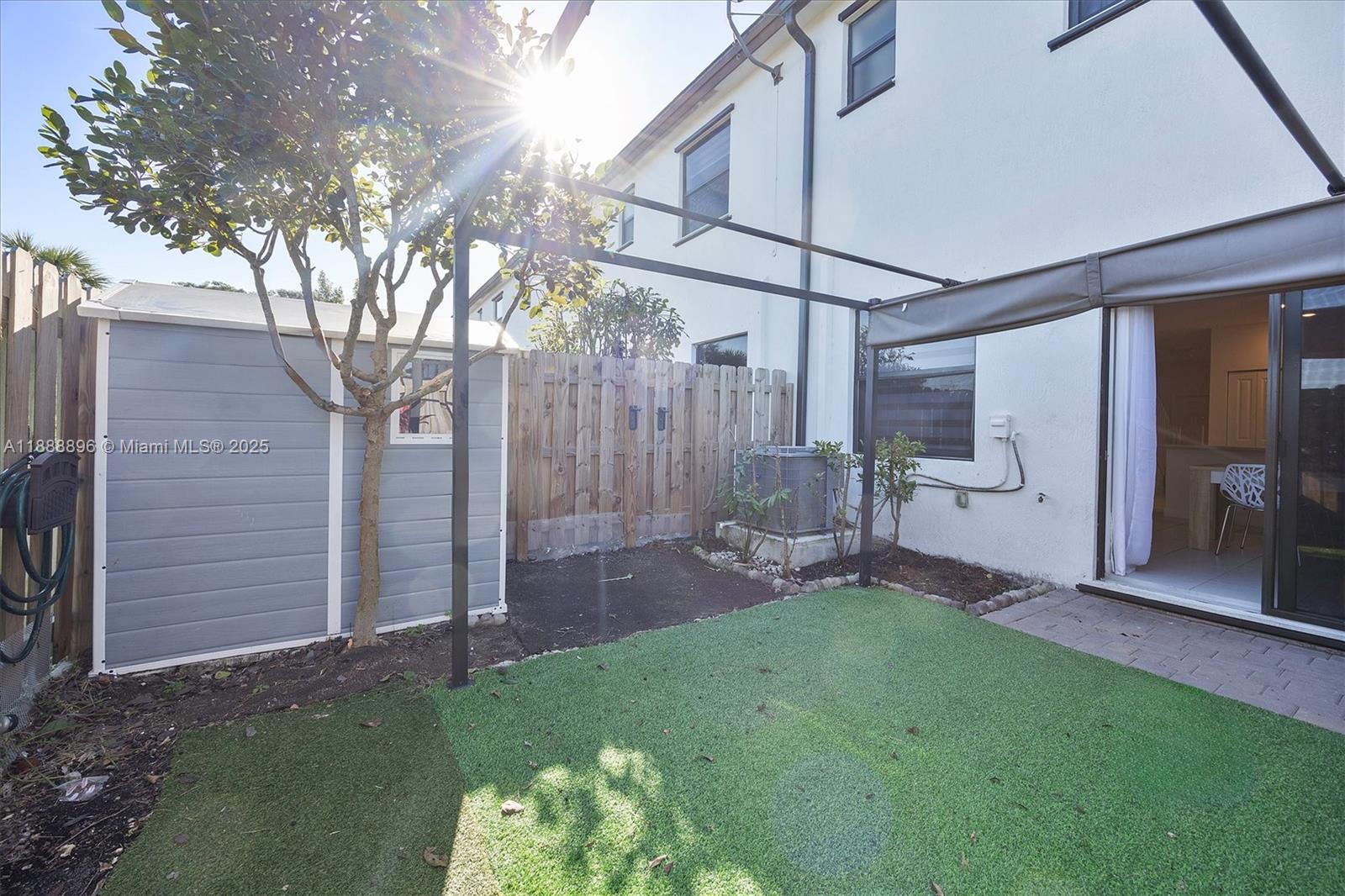 10013 Southwest 228th Terrace, Unit 10013 Miami, FL 33190 - Photo 37 of 39 a backyard of a house with table and chairs