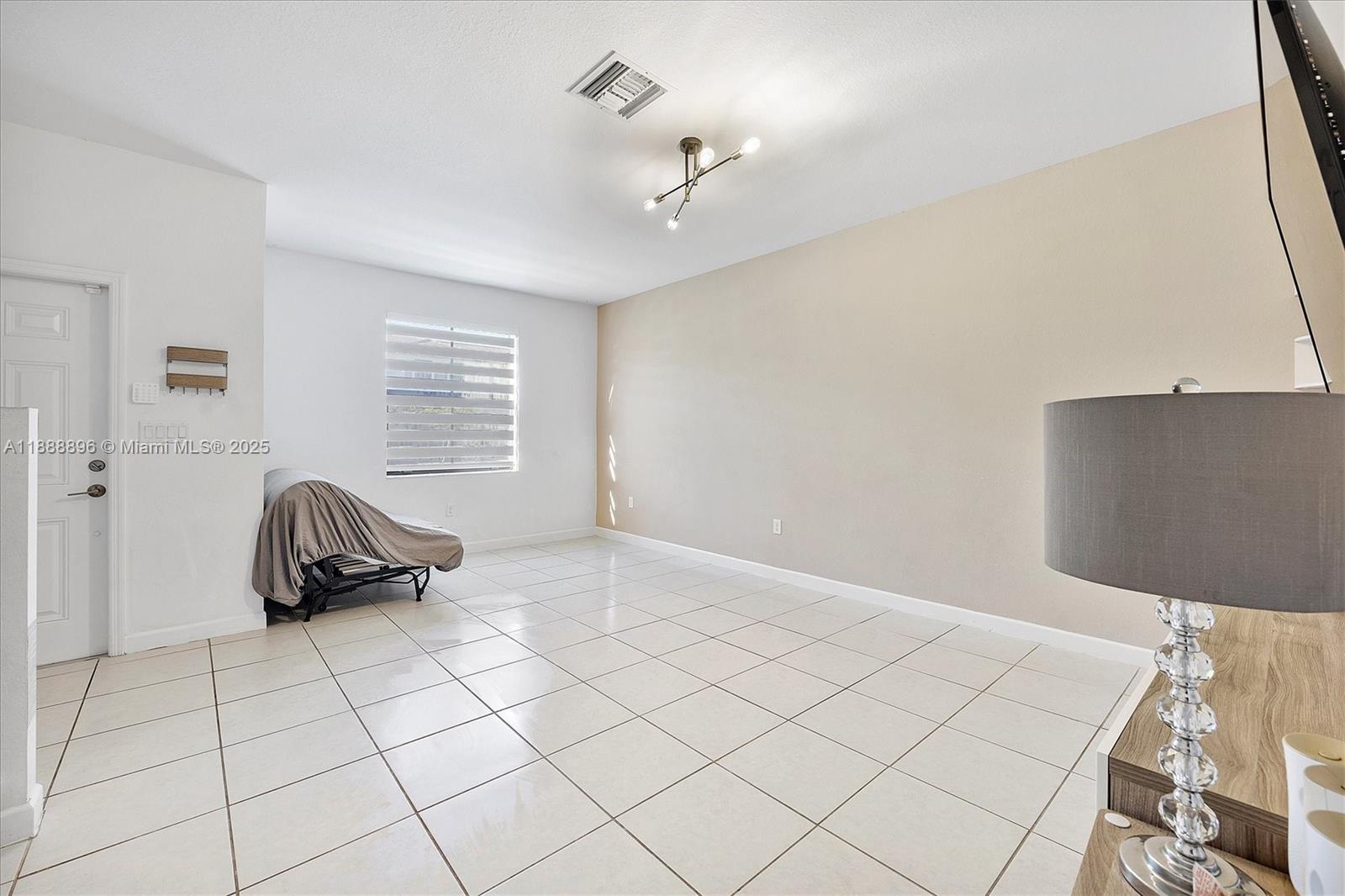 10013 Southwest 228th Terrace, Unit 10013 Miami, FL 33190 - Photo 6 of 39 a bedroom with a bed and a window