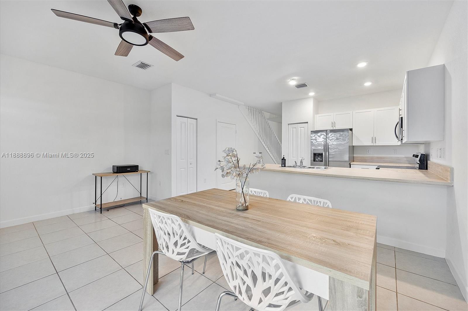 10013 Southwest 228th Terrace, Unit 10013 Miami, FL 33190 - Photo 9 of 39 a kitchen with stainless steel appliances kitchen island granite countertop a sink and cabinets