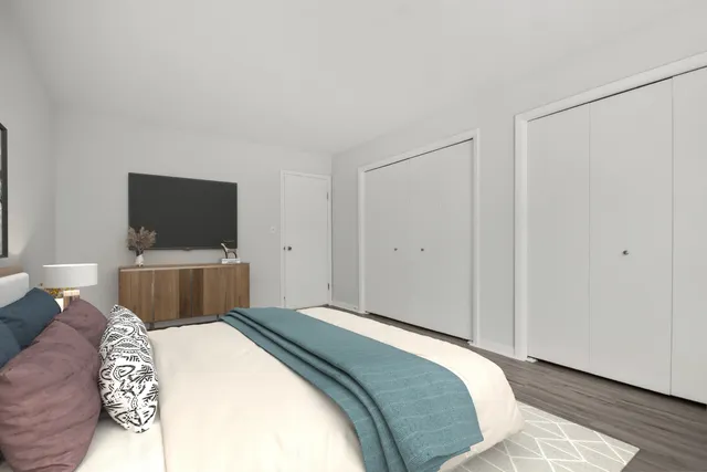 a bedroom with a bed and a flat screen tv