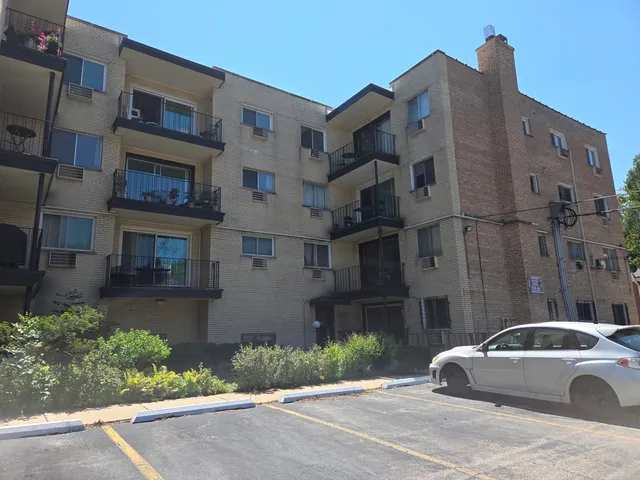a car parked in front of a brick building