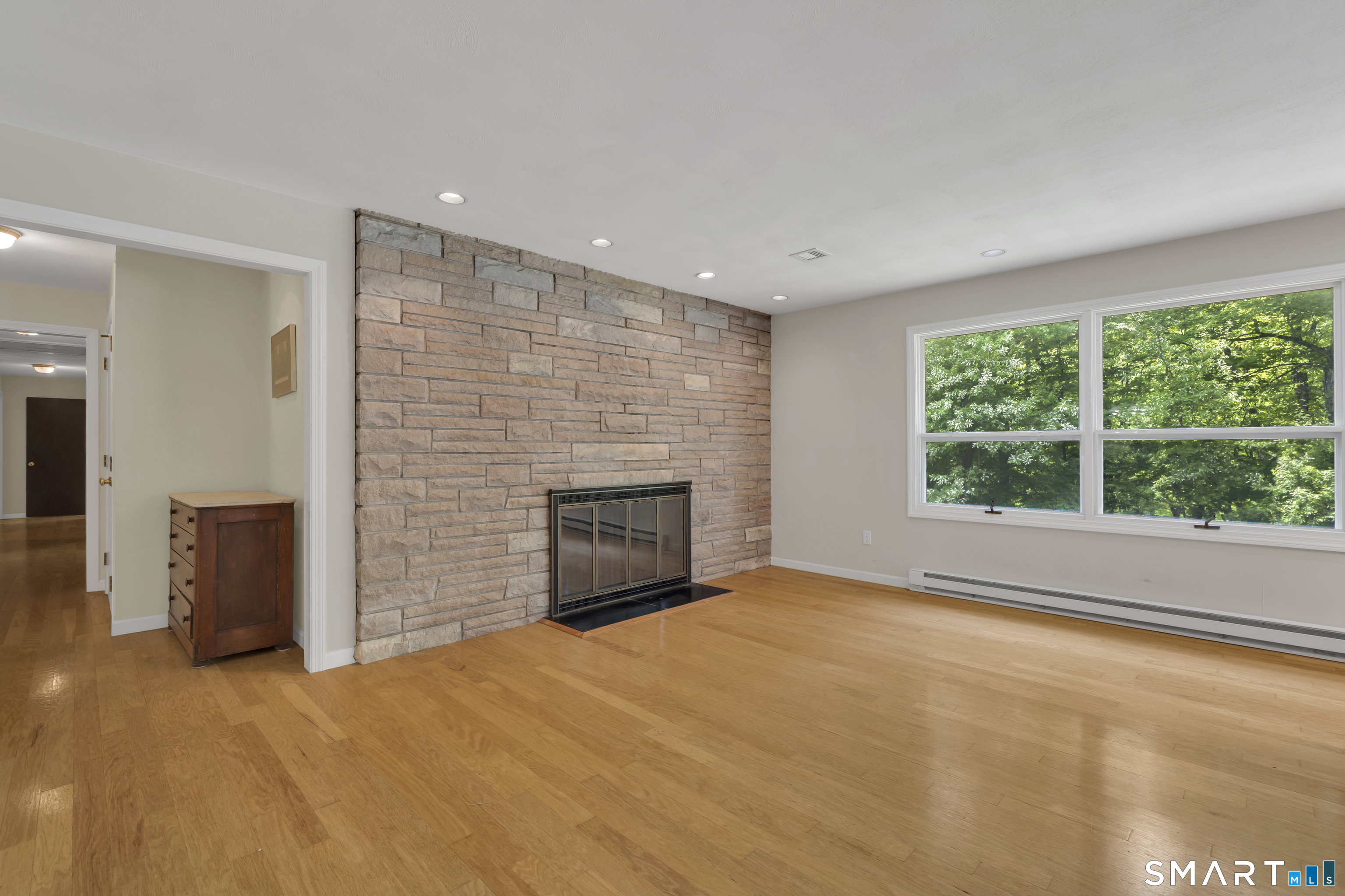 30 Maltbie Road Newtown, CT 06470 - Photo 20 of 40 a view of an empty room with a fireplace and a window