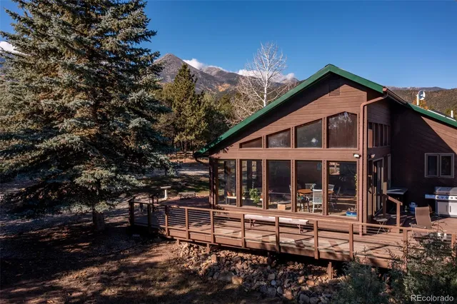 a view of a house with roof and wooden fence