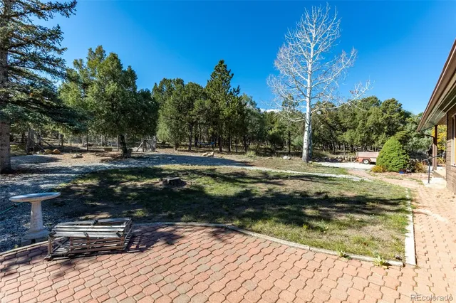 a view of a yard with wooden fence