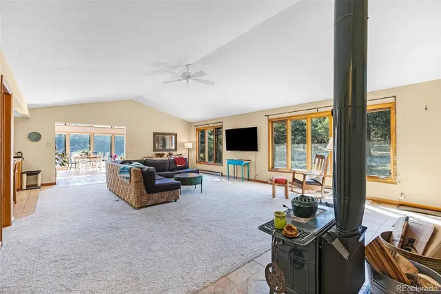 a living room with furniture and large windows