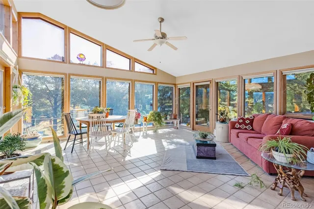 a living room with furniture fireplace and a large window