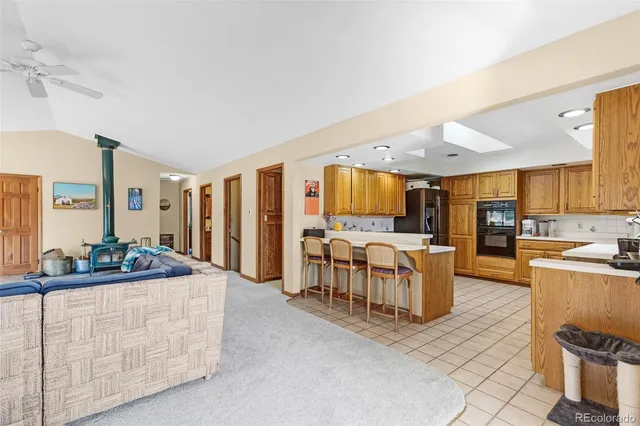 a kitchen with a refrigerator a stove top oven and a sink