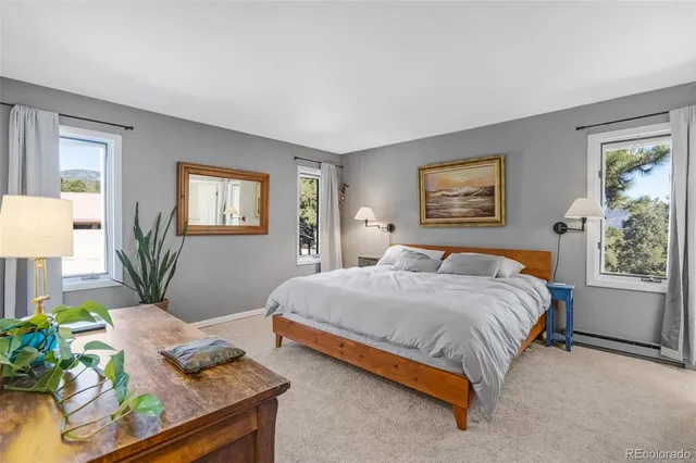 a bathroom with a toilet a sink a mirror a vanity and shower