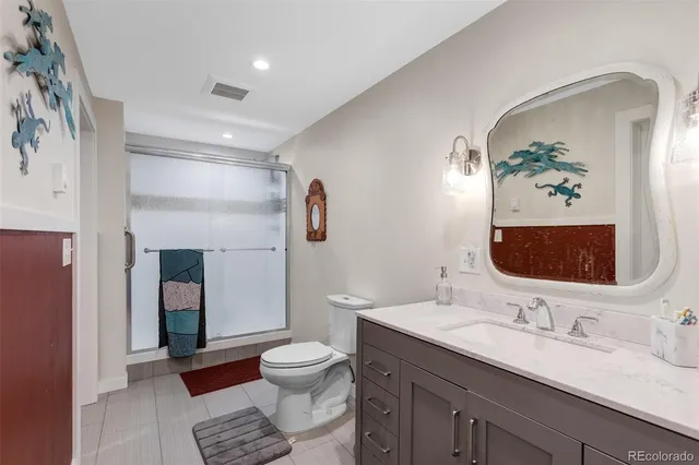 a bedroom with a bed and a night stand