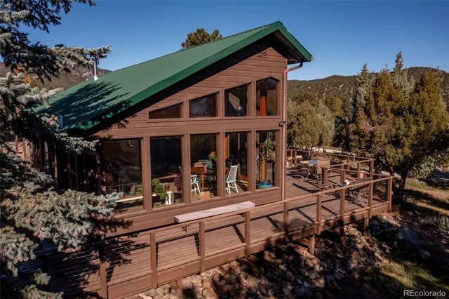 a view of a house with a mountain and a forest