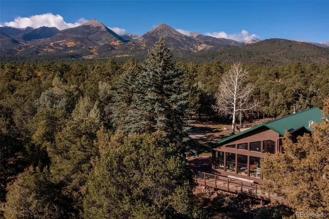 a view of a balcony with chairs and wooden floor
