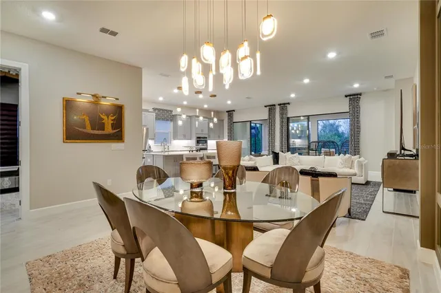 a view of a dining room with furniture and a chandelier