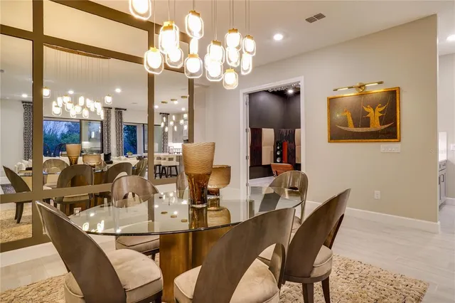 a living room with furniture wooden floor and kitchen view