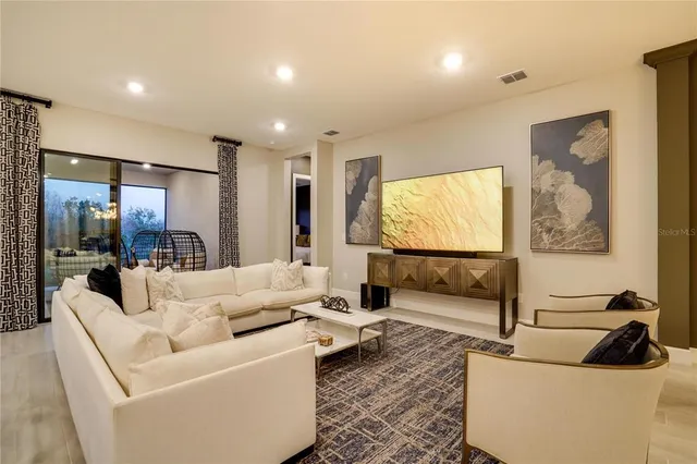 a kitchen with a refrigerator a sink and chairs