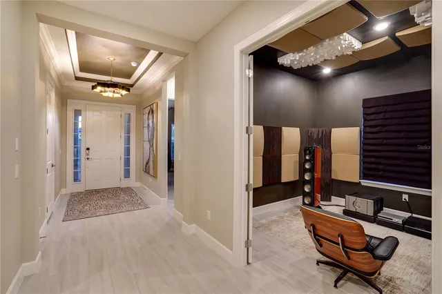 a dining room with wooden floor and a chandelier