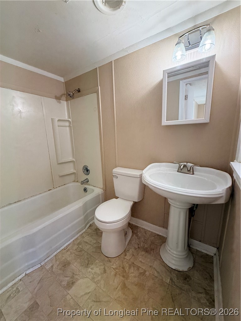 1925 Progress Street Fayetteville, NC 28306 - Photo 11 of 12 a bathroom with a sink toilet and shower