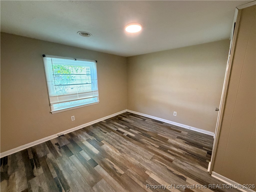 1925 Progress Street Fayetteville, NC 28306 - Photo 9 of 12 an empty room with wooden floor and windows