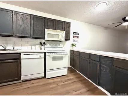 a kitchen with sink cabinets and microwave