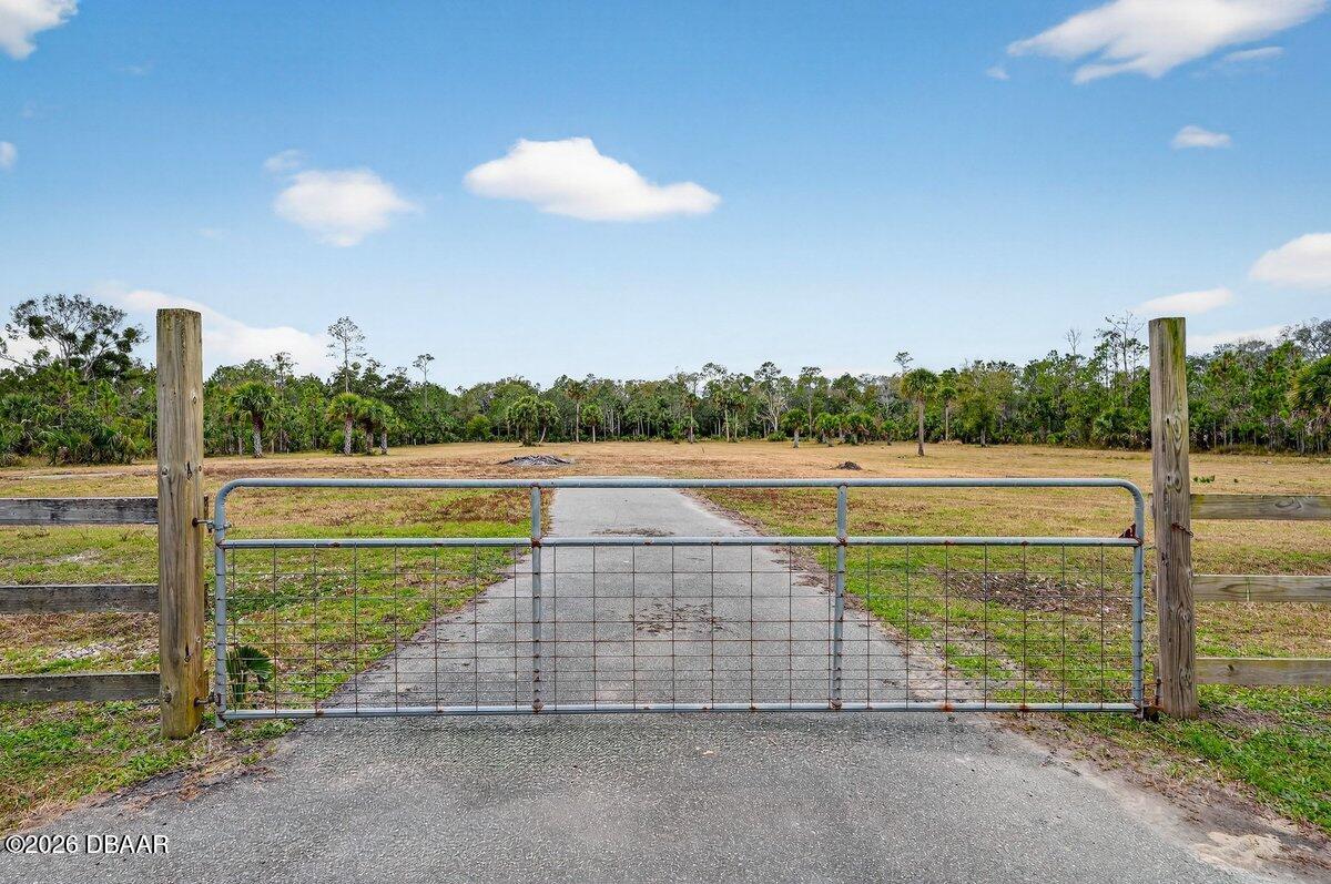 1700 Tomoka Farms Road Port Orange, FL 32128 - Photo 2 of 43 a view of a swimming pool with a yard and seating space