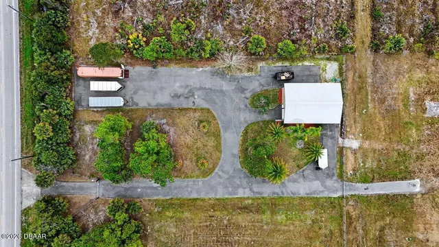 an aerial view of a house with outdoor space