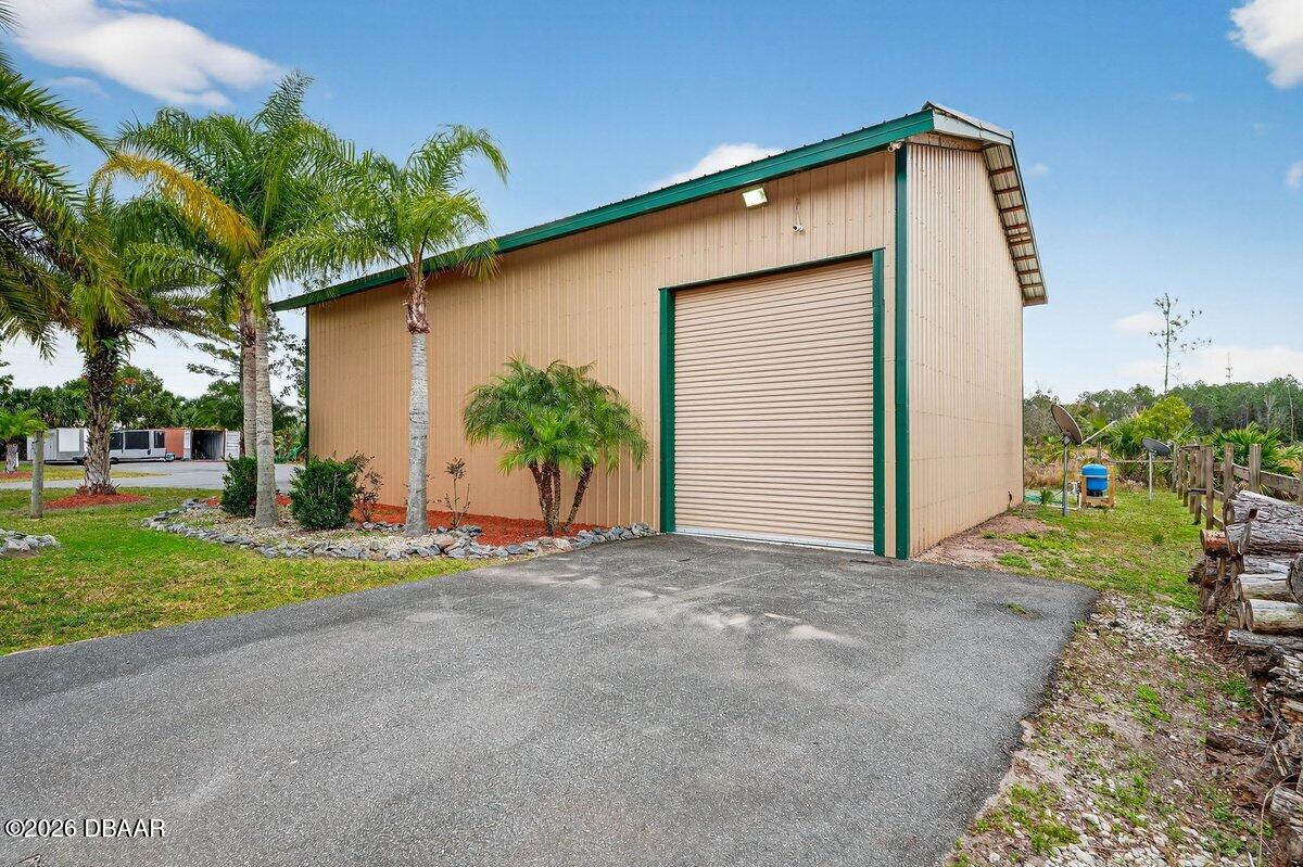 1700 Tomoka Farms Road Port Orange, FL 32128 - Photo 5 of 43 a view of a house with backyard and trees