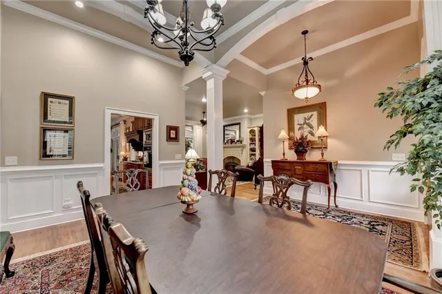 a living room with furniture a fireplace and a floor to ceiling window