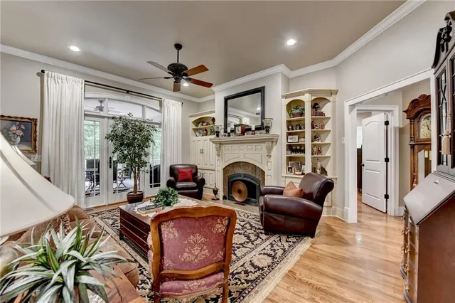 a living room with furniture a fireplace and a chandelier