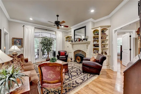 a living room with fireplace furniture and a large window