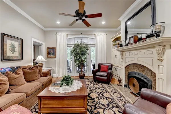 a living room with furniture a fireplace and a chandelier
