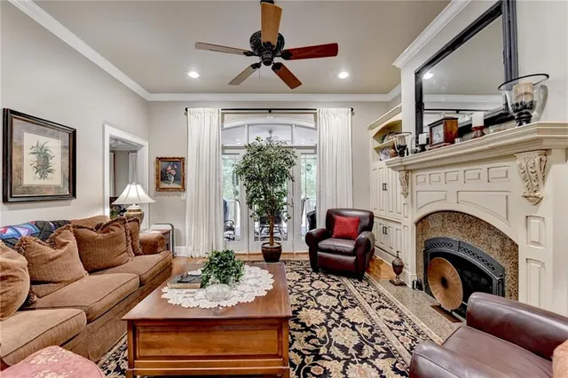 a living room with furniture a fireplace and a chandelier