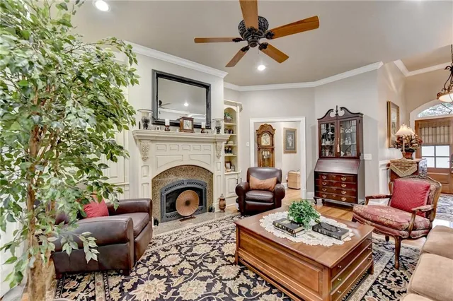 a living room with furniture a flat screen tv and a large window