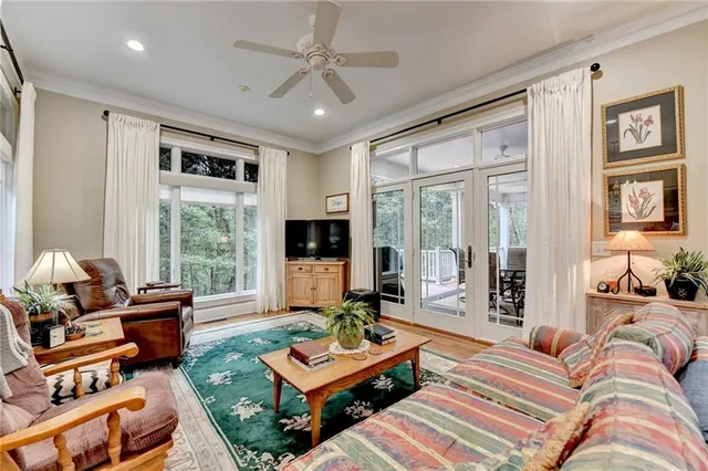 a kitchen with stainless steel appliances granite countertop a kitchen island a stove a refrigerator a oven a dining table and chairs with wooden floor