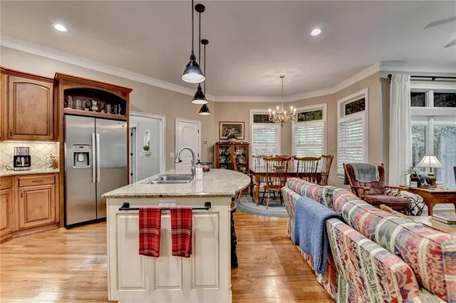 a bedroom with a large bed and a chandelier fan