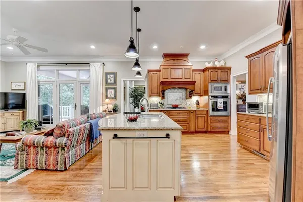 a living room with furniture a ceiling fan and a window