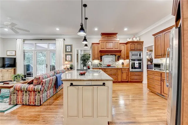 a living room with furniture a ceiling fan and a window