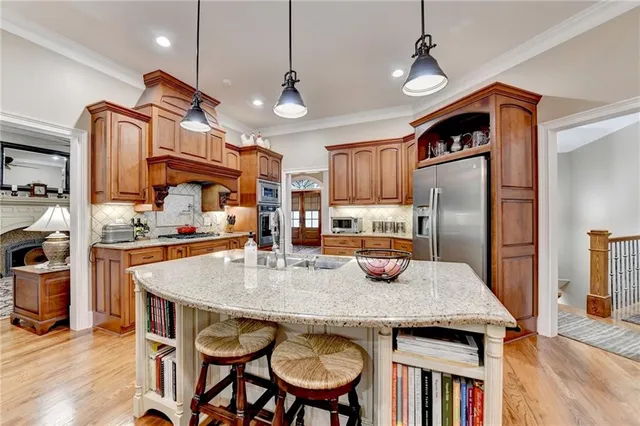 a living room with furniture a flat screen tv and kitchen view