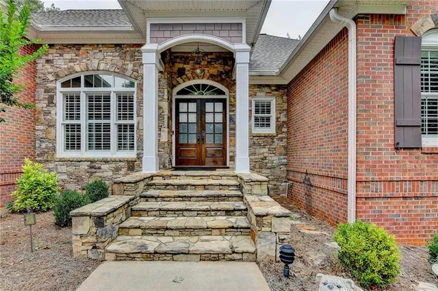 a front view of a house with plants