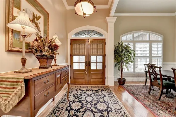 a view of a dining room with furniture and chandelier