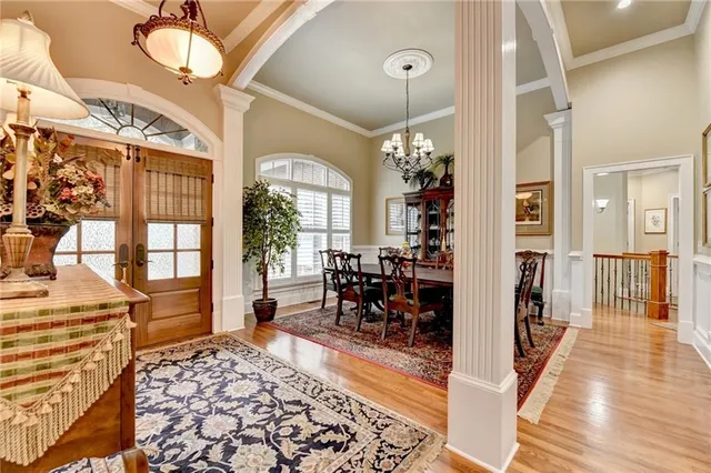 a view of a dining room with furniture and a chandelier