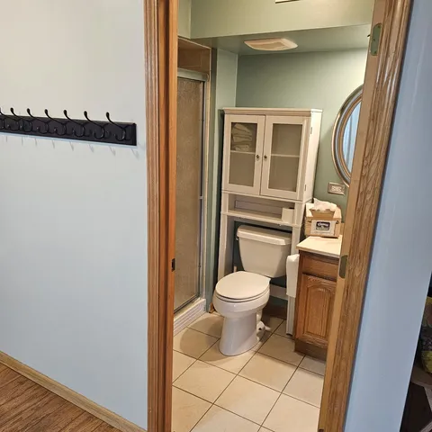 a bathroom with a toilet and a shower