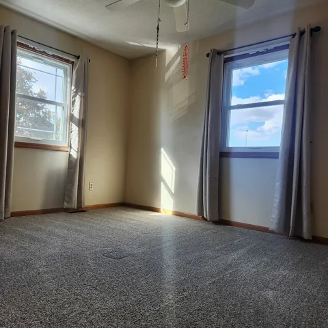 an empty room with windows and closet