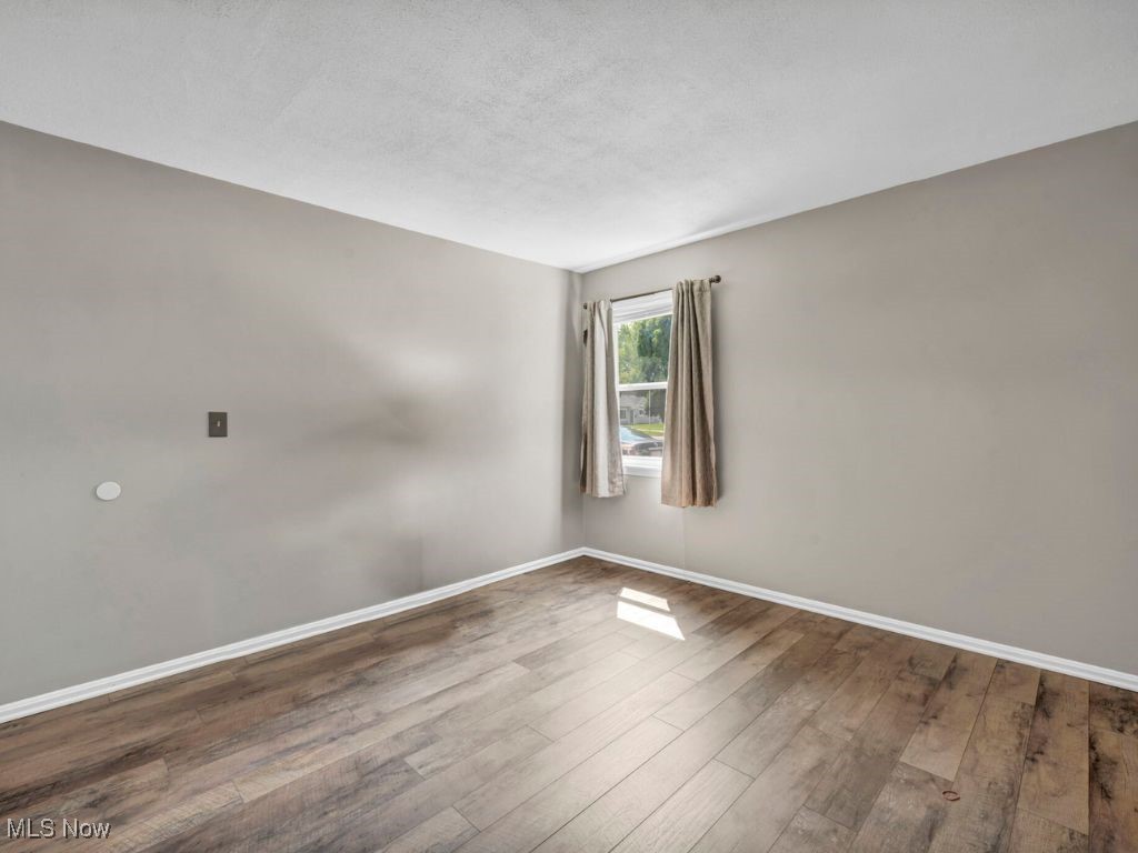 5038 Forest Road Mentor, OH 44060 - Photo 10 of 29 Spare room featuring wood-type flooring