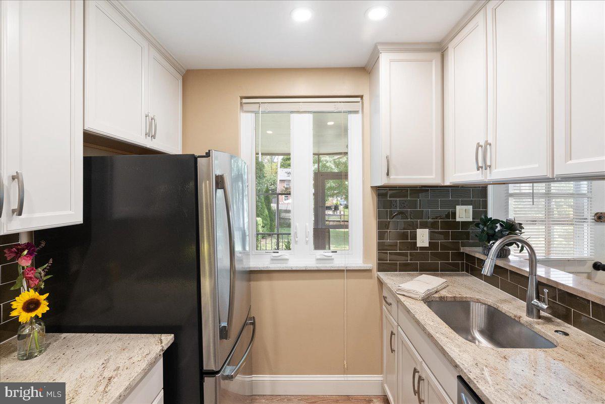 1615 Earlington Road Havertown, PA 19083 - Photo 13 of 72 a kitchen with a sink a refrigerator and cabinets