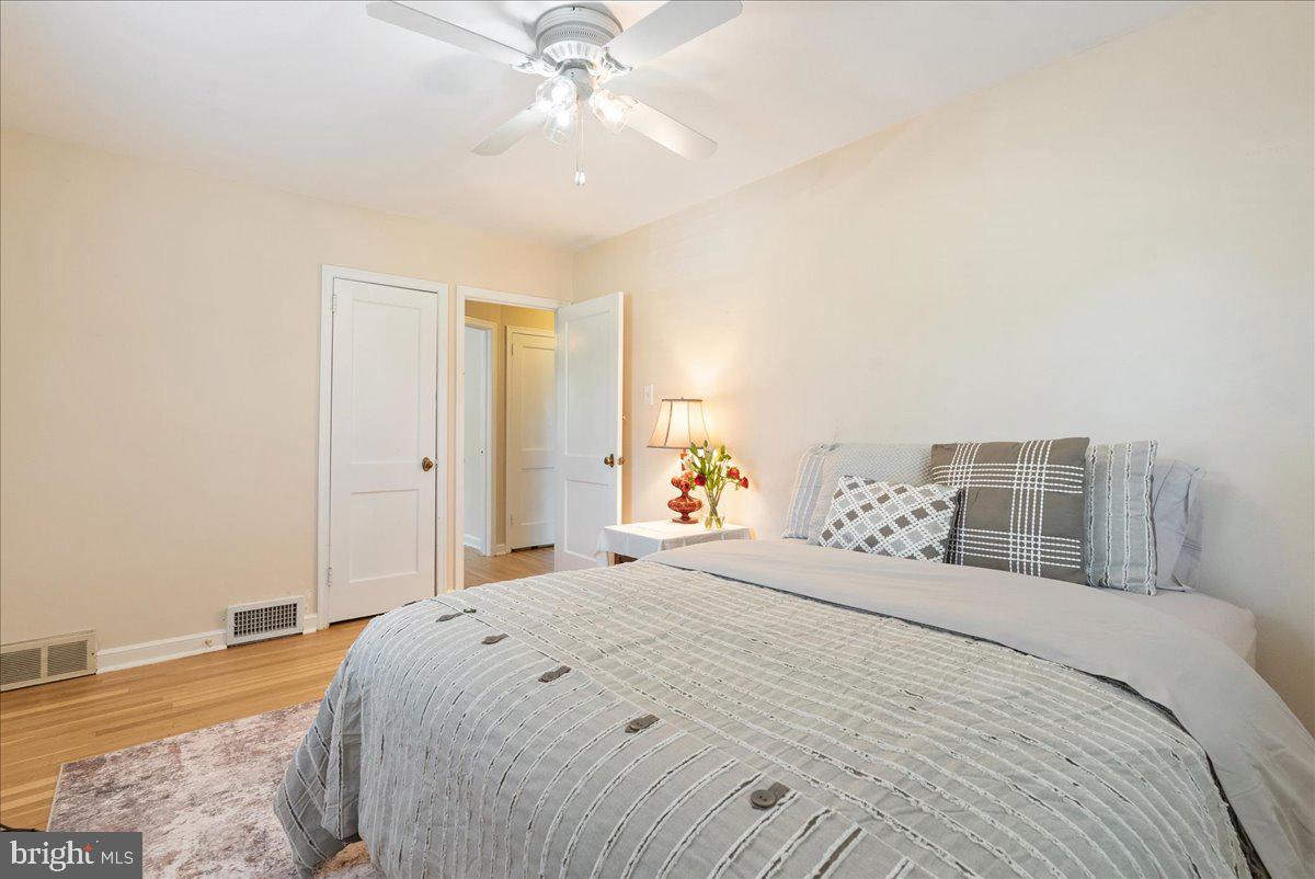 1615 Earlington Road Havertown, PA 19083 - Photo 30 of 72 a bedroom with a large bed and a chandelier